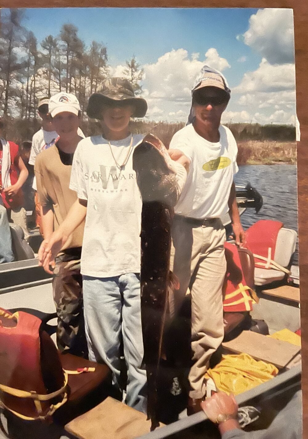 An old printed photograph of a fishing trip in Wisconsin